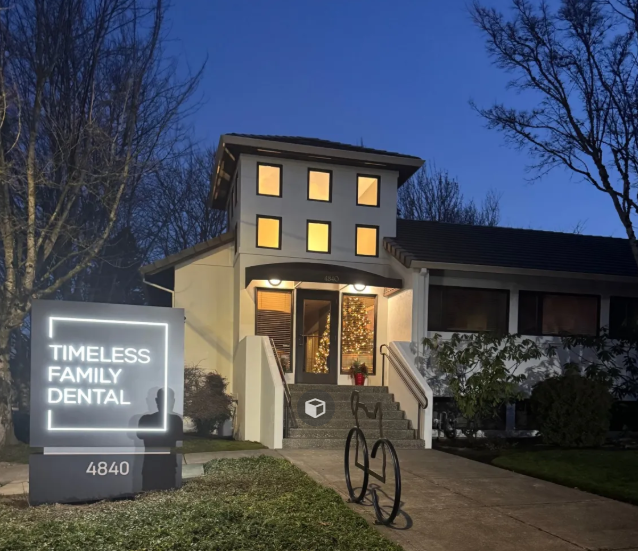 Front view of the office - windows in the front of the building with an LED sign out front. There are 7 steps to the front door